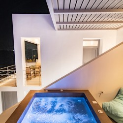 Outdoor jacuzzi with Aegean Sea views on the second terrace of Villa Aegean Colors.
