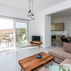 Bright and spacious living room with modern decor at Villa Aegean Colors in Tinos.