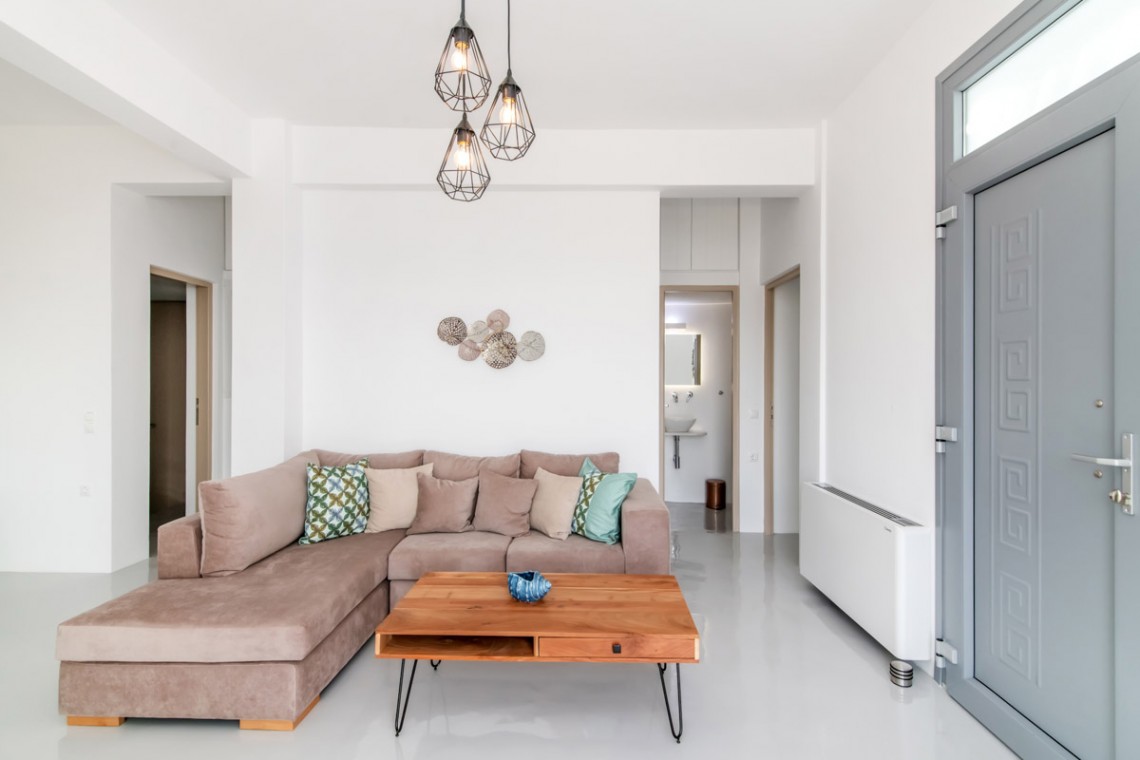 Bright and spacious living room with modern decor at Villa Aegean Colors in Tinos.