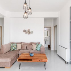 Bright and spacious living room with modern decor at Villa Aegean Colors in Tinos.