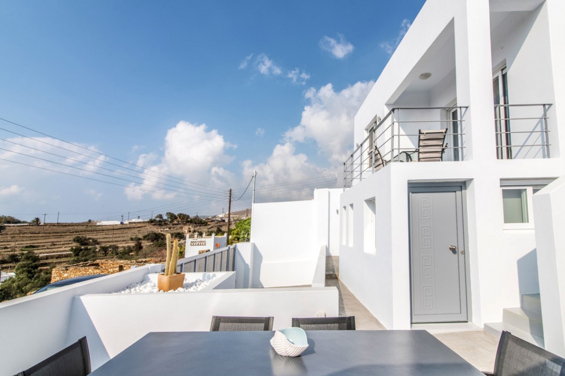 Stunning terrace at Villa Aegean Colors with panoramic views of Agios Fokas Bay, Tinos.