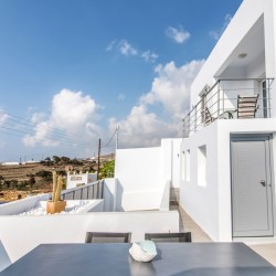 Stunning terrace at Villa Aegean Colors with panoramic views of Agios Fokas Bay, Tinos.