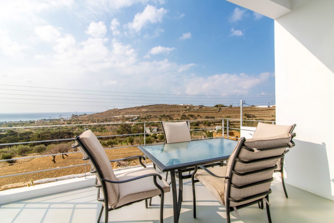 Stunning terrace at Villa Aegean Colors with panoramic views of Agios Fokas Bay, Tinos.