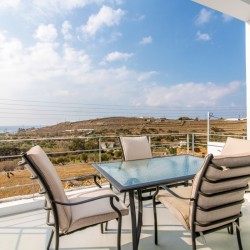 Stunning terrace at Villa Aegean Colors with panoramic views of Agios Fokas Bay, Tinos.