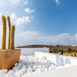 Stunning terrace at Villa Aegean Colors with panoramic views of Agios Fokas Bay, Tinos.