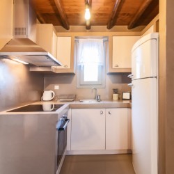 Modern kitchen and dining area in the traditional Triantaros Family House.