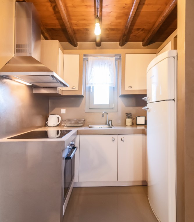 Modern kitchen and dining area in the traditional Triantaros Family House.