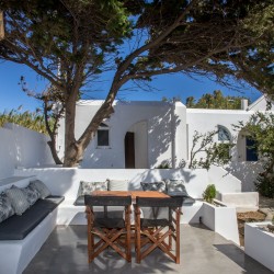 "Side view of the Aegean Sea and garden from the bedroom window of the Tinos accommodation.