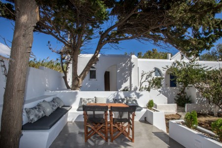 "Side view of the Aegean Sea and garden from the bedroom window of the Tinos accommodation.