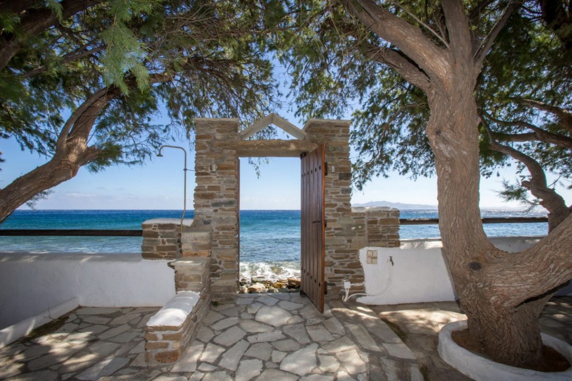 Pebbly Lichnaftia Beach accessible directly through the garden of Tinos Beach House II