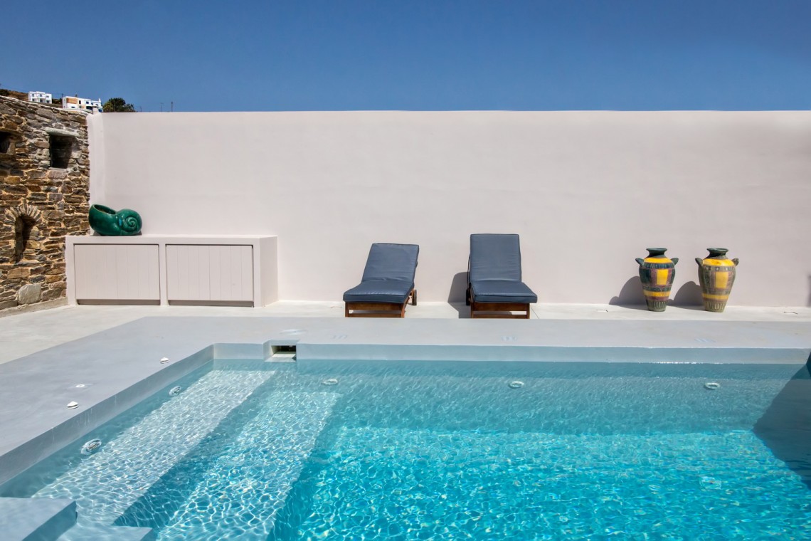 Private pool and sun loungers overlooking the rural landscape at VF Villa, Tinos.