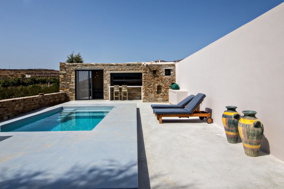 Private pool and sun loungers overlooking the rural landscape at VF Villa, Tinos.