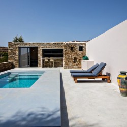 Private pool and sun loungers overlooking the rural landscape at VF Villa, Tinos.