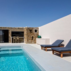 Private pool and sun loungers overlooking the rural landscape at VF Villa, Tinos.