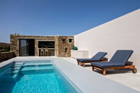 Private pool and sun loungers overlooking the rural landscape at VF Villa, Tinos.