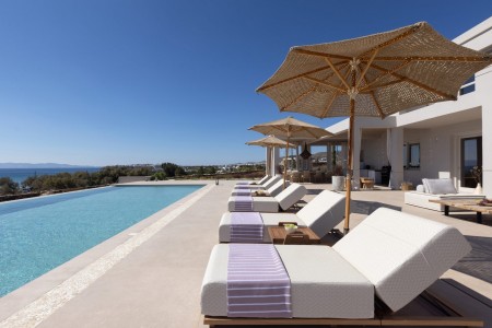 Infinity pool at Villa Dafni in Tinos with stunning views of the Aegean Sea.