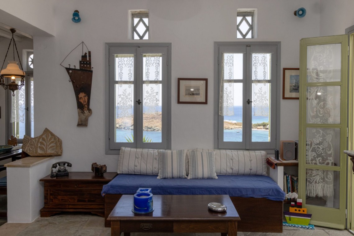 Traditional Tinian stone-built living room at Vivant Blue Mansion with Cycladic arches.