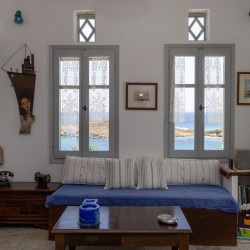 Traditional Tinian stone-built living room at Vivant Blue Mansion with Cycladic arches.