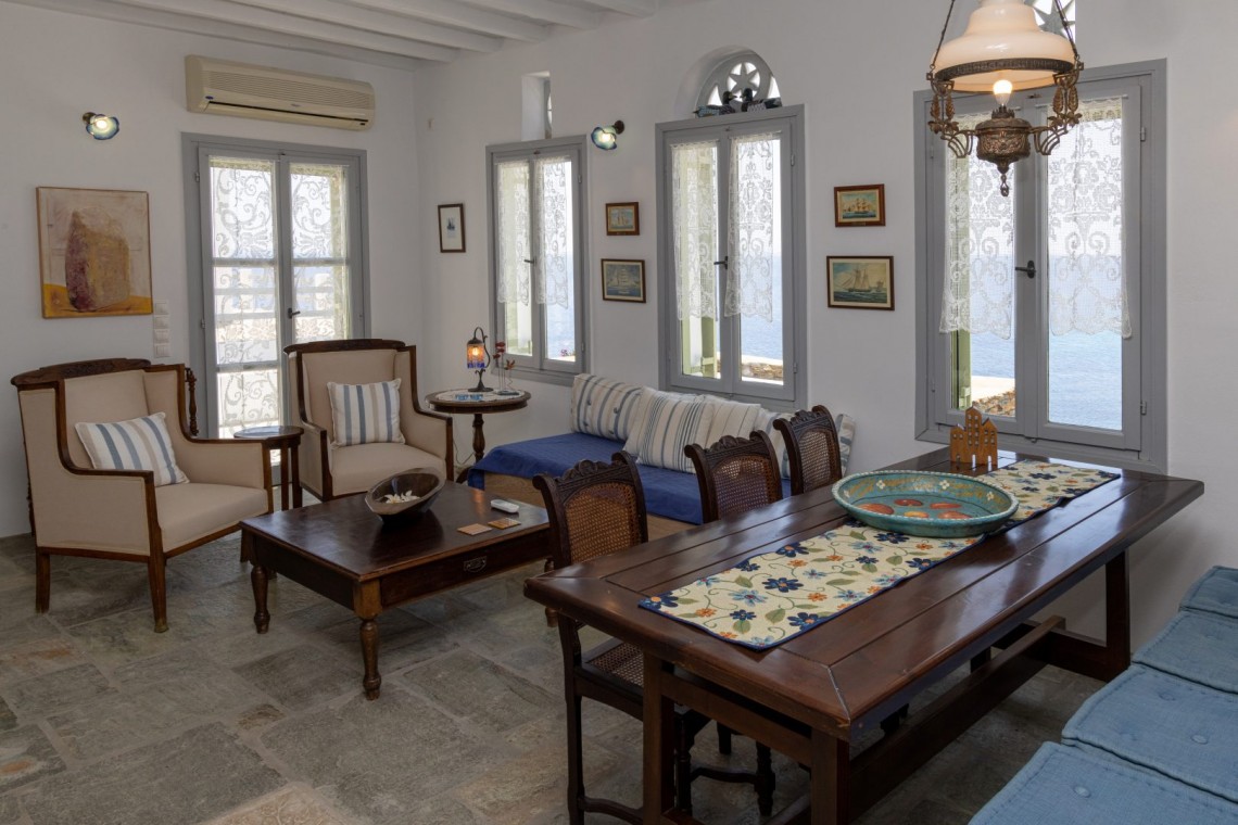 Traditional Tinian stone-built living room at Vivant Blue Mansion with Cycladic arches.