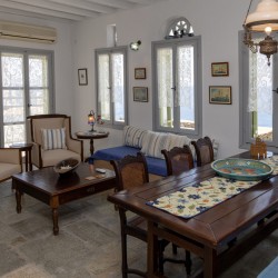 Traditional Tinian stone-built living room at Vivant Blue Mansion with Cycladic arches.