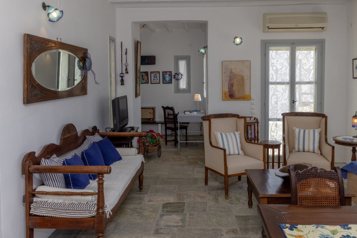 Traditional Tinian stone-built living room at Vivant Blue Mansion with Cycladic arches.