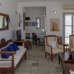 Traditional Tinian stone-built living room at Vivant Blue Mansion with Cycladic arches.