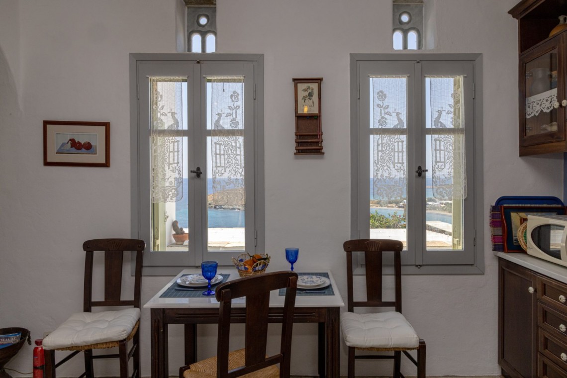 Traditional Tinian stone-built living room at Vivant Blue Mansion with Cycladic arches.