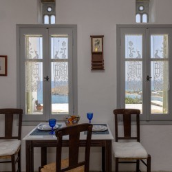 Traditional Tinian stone-built living room at Vivant Blue Mansion with Cycladic arches.