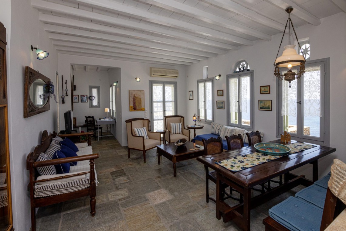 Traditional Tinian stone-built living room at Vivant Blue Mansion with Cycladic arches.