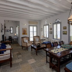 Traditional Tinian stone-built living room at Vivant Blue Mansion with Cycladic arches.
