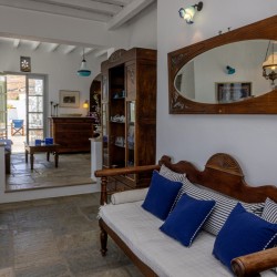 Traditional Tinian stone-built living room at Vivant Blue Mansion with Cycladic arches.