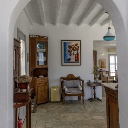 Traditional Tinian stone-built living room at Vivant Blue Mansion with Cycladic arches.
