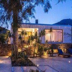Path through the garden leading to the pebbly Lichnaftia Beach in Tinos.