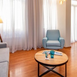 Spacious living room with modern furniture and artistic décor at Tinos La Belle Vie.