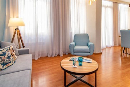 Spacious living room with modern furniture and artistic décor at Tinos La Belle Vie.