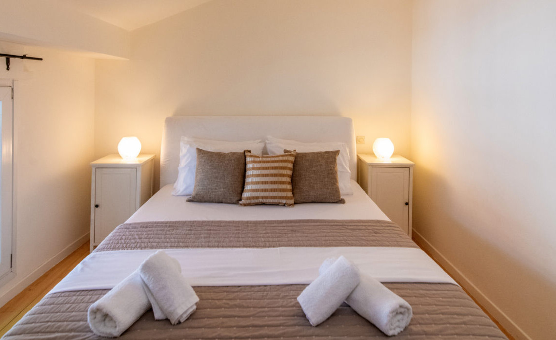 Cozy double bedroom with independent air conditioning in Belle Époque Tinos apartment.