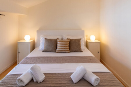 Cozy double bedroom with independent air conditioning in Belle Époque Tinos apartment.