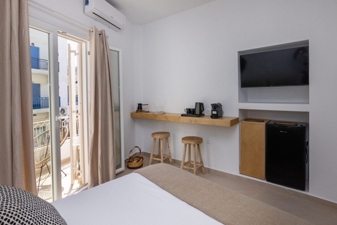Comfortable queen-size bed in Alora Major Suite, offering a luxurious and restful experience in Tinos Town.