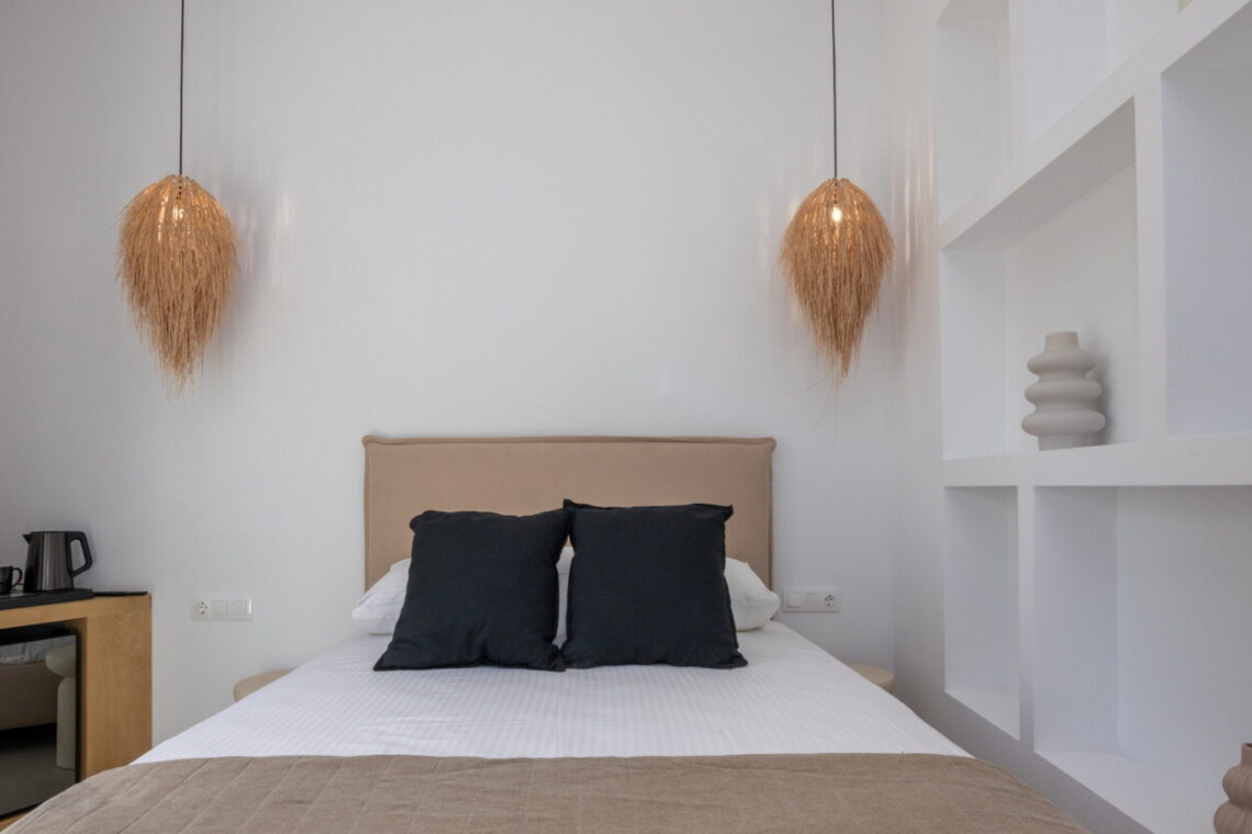 Comfortable queen-size bed in Alora Major Suite, offering a luxurious and restful experience in Tinos Town.