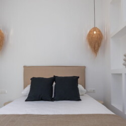 Comfortable queen-size bed in Alora Major Suite, offering a luxurious and restful experience in Tinos Town.