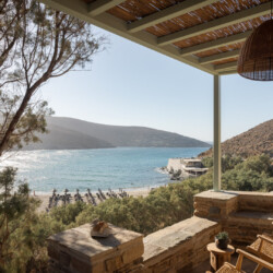 Rabela’s House exterior view at Kolibithra Beach, Tinos Island – beachfront accommodation surrounded by scenic beauty.