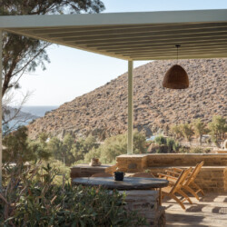 Rabela’s House exterior view at Kolibithra Beach, Tinos Island – beachfront accommodation surrounded by scenic beauty.