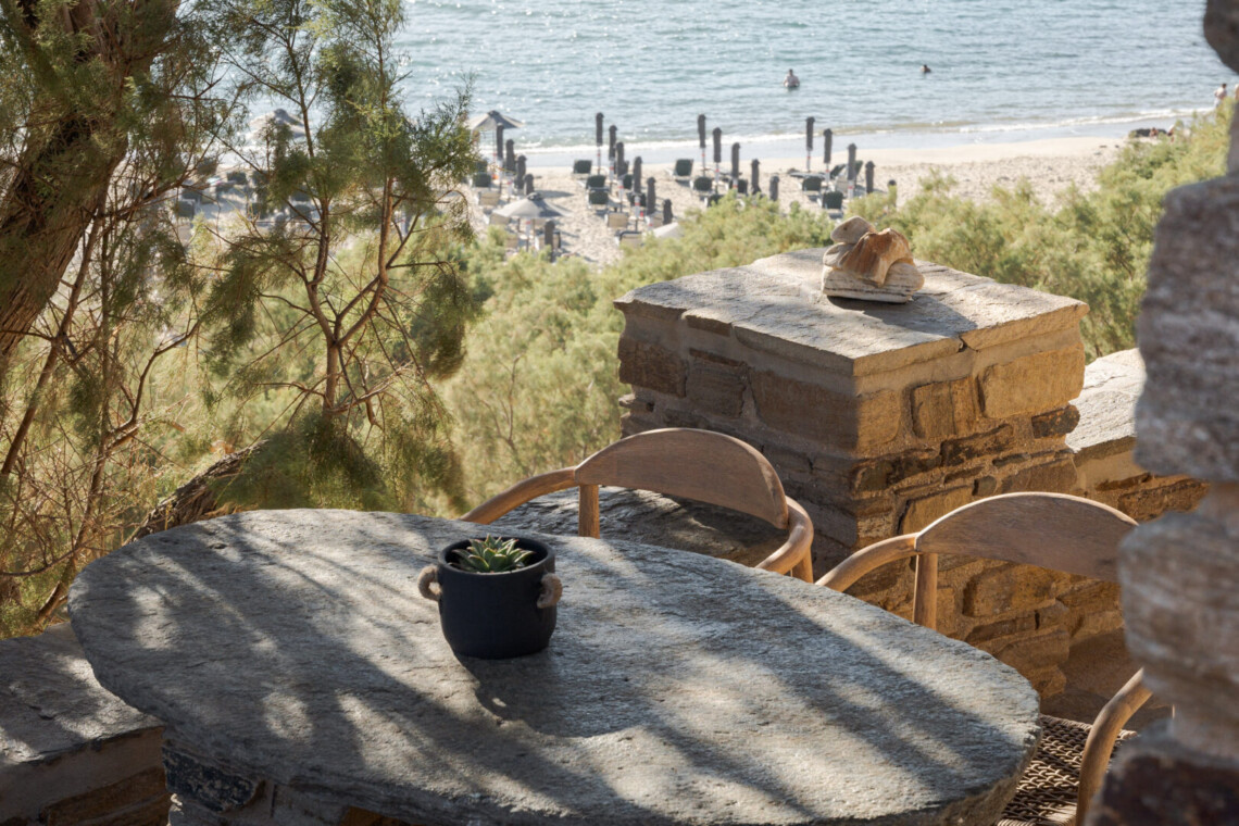 Rabela’s House exterior view at Kolibithra Beach, Tinos Island – beachfront accommodation surrounded by scenic beauty.