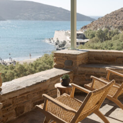 Rabela’s House exterior view at Kolibithra Beach, Tinos Island – beachfront accommodation surrounded by scenic beauty.