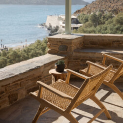 Rabela’s House exterior view at Kolibithra Beach, Tinos Island – beachfront accommodation surrounded by scenic beauty.