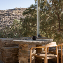Rabela’s House exterior view at Kolibithra Beach, Tinos Island – beachfront accommodation surrounded by scenic beauty.