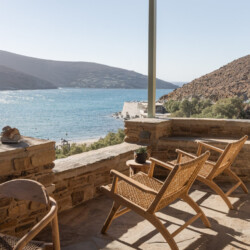Rabela’s House exterior view at Kolibithra Beach, Tinos Island – beachfront accommodation surrounded by scenic beauty.