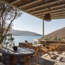 Rabela’s House exterior view at Kolibithra Beach, Tinos Island – beachfront accommodation surrounded by scenic beauty.